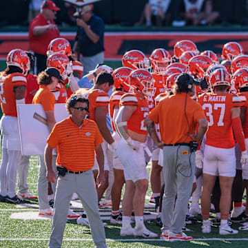 Oct 5, 2024; Stillwater, Oklahoma, USA; Oklahoma State Cowboys coach Mike Gundy on the field with his team during a break in play of the third quarter against the West Virginia Mountaineers at Boone Pickens Stadium. Mandatory Credit: William Purnell-Imagn Images
