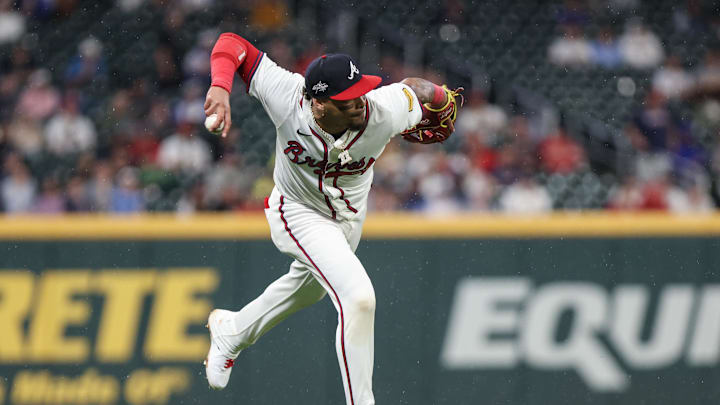 Apr 22, 2025; Cumberland, Georgia, USA; Atlanta Braves shortstop Orlando Arcia (11) fields the ball and attempts for an out against the St. Louis Cardinals during the eighth inning at Truist Park. Mandatory Credit: Jordan Godfree-Imagn Images