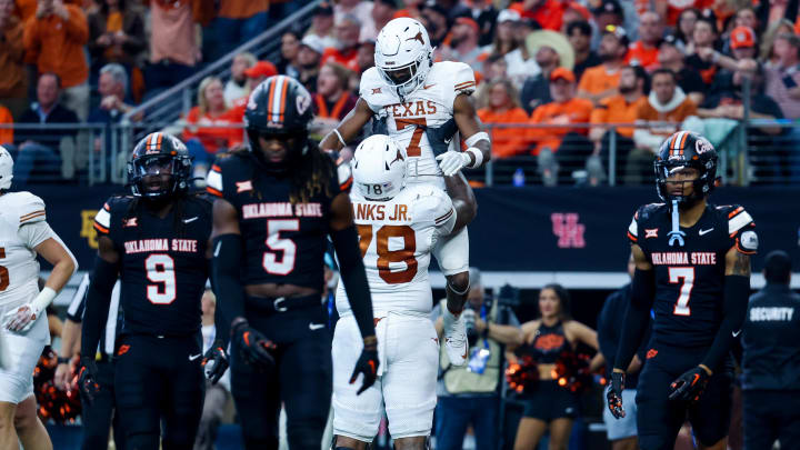 Dec 2, 2023; Arlington, TX, USA;  Texas Longhorns running back Keilan Robinson (7)  celebrates with Texas Longhorns offensive lineman Kelvin Banks Jr. (78) after scoring a touchdown during the second half against the Oklahoma State Cowboys at AT&T Stadium. Mandatory Credit: Kevin Jairaj-USA TODAY Sports