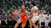 Dec 7, 2024; Coral Gables, Florida, USA; Clemson Tigers guard Jaeden Zackery (11) drives to the basket past Miami Hurricanes guard Nijel Pack (24) during the first half at Watsco Center. 