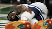 Dec 30, 2022; Milwaukee, Wisconsin, USA;  Minnesota Timberwolves guard Anthony Edwards (1) holds his leg after falling to the floor during the fourth quarter against the Milwaukee Bucks at Fiserv Forum. Mandatory Credit: Jeff Hanisch-Imagn Images