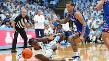 Nov 7, 2025; Chapel Hill, North Carolina, USA;  North Carolina Tar Heels forward Caleb Wilson (8) adn Kansas Jayhawks guard Tre White (3) fight for the ball in the first half at Dean E. Smith Center. Mandatory Credit: Bob Donnan-Imagn Images