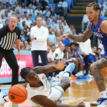 Nov 7, 2025; Chapel Hill, North Carolina, USA;  North Carolina Tar Heels forward Caleb Wilson (8) adn Kansas Jayhawks guard Tre White (3) fight for the ball in the first half at Dean E. Smith Center. Mandatory Credit: Bob Donnan-Imagn Images