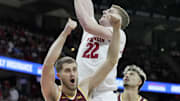 Wisconsin forward Steven Crowl (22) makes a shot and Minnesota forward Parker Fox (23) reacts to a call during the second half of their game Friday, January 10, 2025 at the Kohl Center in Madison, Wisconsin. Wisconsin beat Minnesota 80-59.