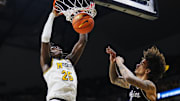 Feb 8, 2025; Columbia, Missouri, USA; Missouri Tigers guard Mark Mitchell (25) dunks the ball against Texas A&M Aggies forward Andersson Garcia (11) during the first half at Mizzou Arena. Mandatory Credit: Jay Biggerstaff-Imagn Images