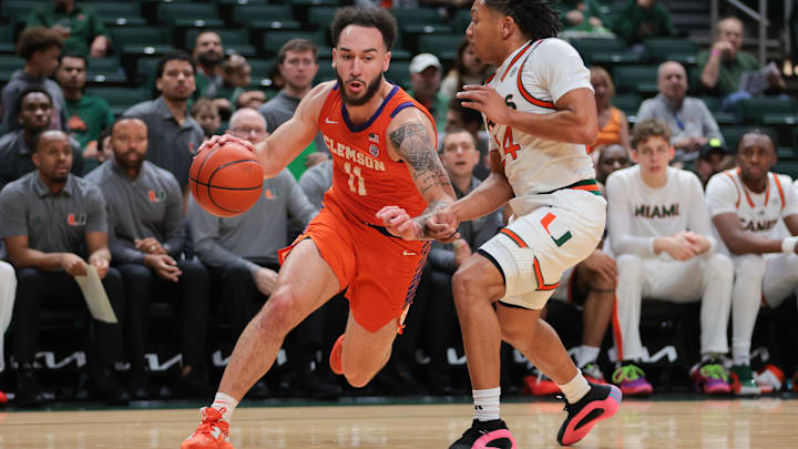 Dec 7, 2024; Coral Gables, Florida, USA; Clemson Tigers guard Jaeden Zackery (11) drives to the basket past Miami Hurricanes guard Nijel Pack (24) during the first half at Watsco Center. Mandatory Credit: Sam Navarro-Imagn Images
