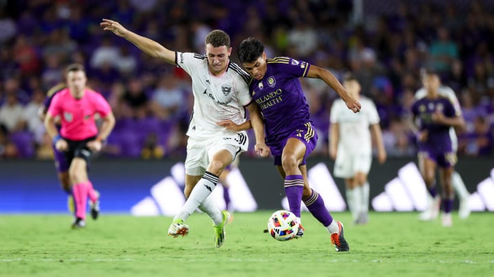 Jul 6, 2024; Orlando, Florida, USA; Orlando City forward Ramiro Enrique (7) and D.C. United defender Christopher McVey (97) battle for the ball in the second half at Inter&Co Stadium. Mandatory Credit: Nathan Ray Seebeck-USA TODAY Sports