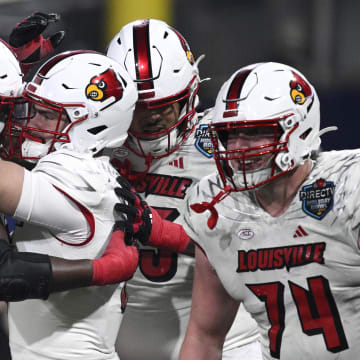 Louisville Cardinals quarterback Evan Conley (6) celebrates with teammates after scoring a touchdown against the USC Trojans during the first half at Petco Park. 