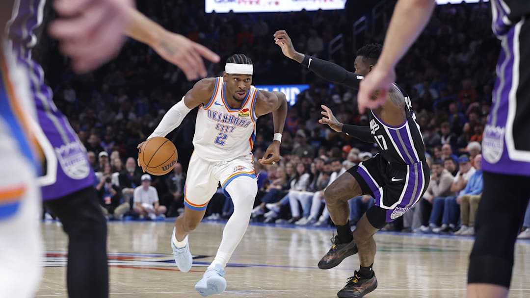 Oct 28, 2025; Oklahoma City, Oklahoma, USA; Oklahoma City Thunder guard Shai Gilgeous-Alexander (2) drives down the court against Sacramento Kings guard Dennis Schroder (17) during the second half at Paycom Center. Mandatory Credit: Alonzo Adams-Imagn Images
