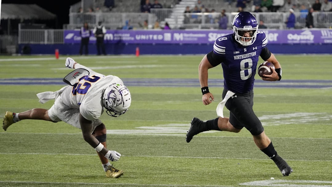 Sep 5, 2025; Evanston, Illinois, USA; Western Illinois Leathernecks defensive back Malini Ti'a (33) defends Northwestern Wildcats quarterback Preston Stone (8) during the second half at Northwestern Medicine Field at Martin Stadium. Mandatory Credit: David Banks-Imagn Images