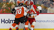 Nov 2, 2025; Philadelphia, Pennsylvania, USA; Calgary Flames center Mikael Backlund (11) battle for the puck with Philadelphia Flyers right wing Bobby Brink (10) during the third period at Xfinity Mobile Arena. Mandatory Credit: Eric Hartline-Imagn Images