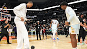 Apr 13, 2025; San Antonio, Texas, USA; San Antonio Spurs center Victor Wembanyama (1) and forward Harrison Ingram (55) play around with a ball in celebration of Fan Appreciation Day after a victory over the Toronto Raptors at Frost Bank Center. Mandatory Credit: Scott Wachter-Imagn Images