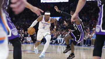 Oct 28, 2025; Oklahoma City, Oklahoma, USA; Oklahoma City Thunder guard Shai Gilgeous-Alexander (2) drives down the court against Sacramento Kings guard Dennis Schroder (17) during the second half at Paycom Center. Mandatory Credit: Alonzo Adams-Imagn Images