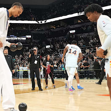 Apr 13, 2025; San Antonio, Texas, USA; San Antonio Spurs center Victor Wembanyama (1) and forward Harrison Ingram (55) play around with a ball in celebration of Fan Appreciation Day after a victory over the Toronto Raptors at Frost Bank Center. Mandatory Credit: Scott Wachter-Imagn Images