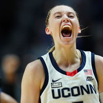 Mar 10, 2024; Uncasville, CT, USA; UConn Huskies guard Paige Bueckers (5) reacts after her three point basket against the Marquette Golden Eagles in the second half at Mohegan Sun Arena. Mandatory Credit: David Butler II-Imagn Images