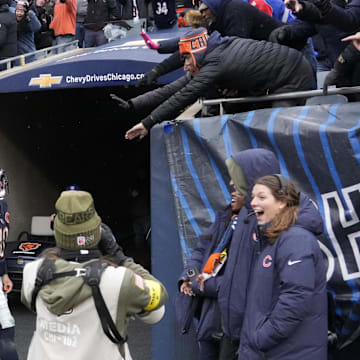 Caleb Williams celebrates with fans after scoring on a 17-yard run for the 24-20 win at Soldier Field.