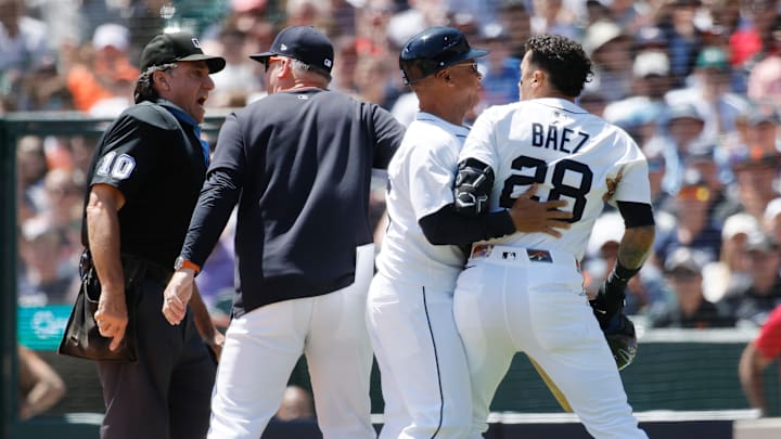 Javier Baez is restrained by a Detroit Tigers coach while trying to argue with home plate umpire Phil Cuzzi. Javier Baez is restrained by a Detroit Tigers coach while trying to argue with home plate umpire Phil Cuzzi.