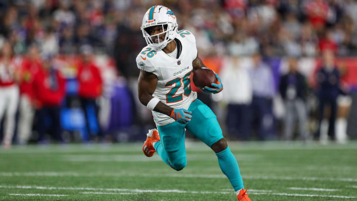 Miami Dolphins running back Salvon Ahmed (26) runs the ball during the first half against the New England Patriots at Gillette Stadium last season.