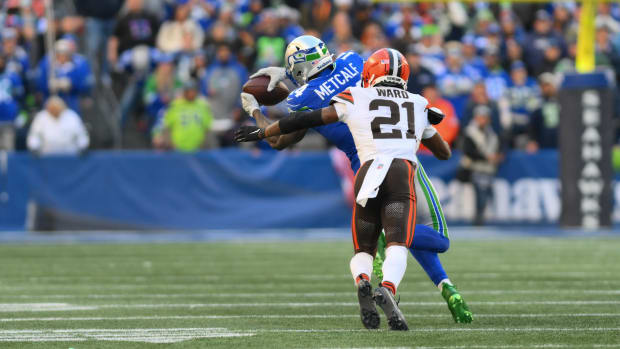 Cornerback tackles receiver after catch.