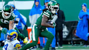 New York Jets wide receiver Allen Lazard (10) takes care of Los Angeles Rams cornerback Ahkello Witherspoon (4) as New York Jets wide receiver Davante Adams (17) continues with the ball after completing a pass for a first down in the second quarter, Sunday, December 22, 2024, in East Rutherford.