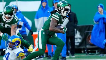 New York Jets wide receiver Allen Lazard (10) takes care of Los Angeles Rams cornerback Ahkello Witherspoon (4) as New York Jets wide receiver Davante Adams (17) continues with the ball after completing a pass for a first down in the second quarter, Sunday, December 22, 2024, in East Rutherford.
