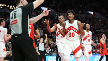 Mar 16, 2025; Portland, Oregon, USA; Toronto Raptors guard Ochai Agbaji (30) and Raptors’ center Orlando Robinson (21) react after being called for a foul against Portland Trail Blazers in the second half at Moda Center. Mandatory Credit: Jaime Valdez-Imagn Images