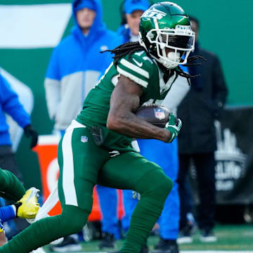 New York Jets wide receiver Allen Lazard (10) takes care of Los Angeles Rams cornerback Ahkello Witherspoon (4) as New York Jets wide receiver Davante Adams (17) continues with the ball after completing a pass for a first down in the second quarter, Sunday, December 22, 2024, in East Rutherford.
