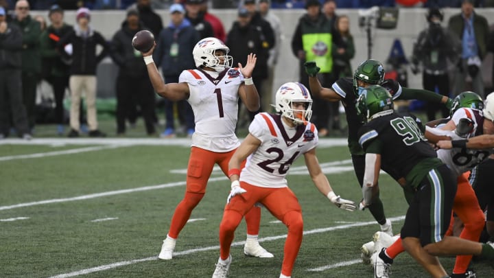 Dec 27, 2023; Annapolis, MD, USA;  Virginia Tech Hokies quarterback Kyron Drones (1) throws to tight end Harrison Saint Germain (87)  for a second quarter touchdown against the Tulane Green Wave at Navy-Marine Corps Memorial Stadium. Mandatory Credit: Tommy Gilligan-USA TODAY Sports