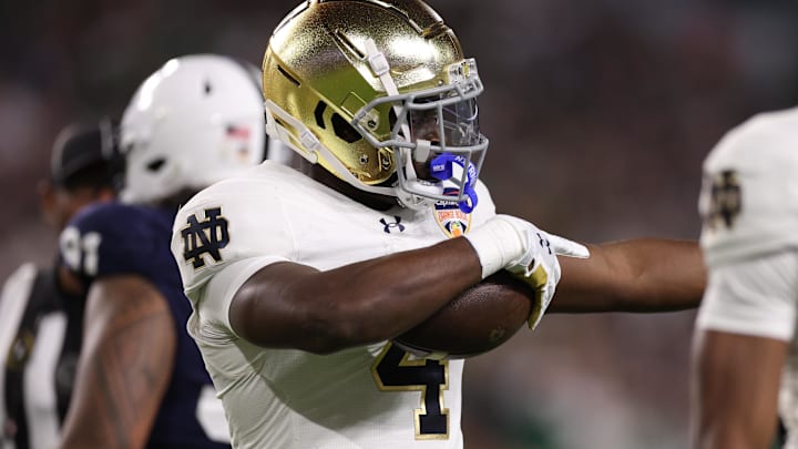 Notre Dame Fighting Irish running back Jeremiyah Love celebrates a first down against the Penn State Nittany Lions in the Orange Bowl Notre Dame Fighting Irish running back Jeremiyah Love celebrates a first down against the Penn State Nittany Lions in the Orange Bowl