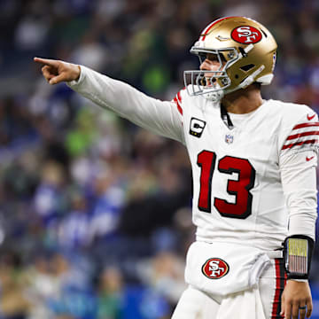 Oct 10, 2024; Seattle, Washington, USA; San Francisco 49ers quarterback Brock Purdy (13) celebrates after throwing a touchdown pass against the Seattle Seahawks during the fourth quarter at Lumen Field. Mandatory Credit: Joe Nicholson-Imagn Images