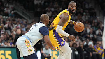 Los Angeles Lakers forward LeBron James (23) dribbles against San Antonio Spurs guard Chris Paul (3) in the second half at Frost Bank Center.