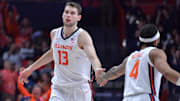 Feb 11, 2025; Champaign, Illinois, USA;  Illinois Fighting Illini center Tomislav Ivisic (13) gets a hand from teammate  Kylan Boswell (4) during the second half against the UCLA Bruins at State Farm Center. Mandatory Credit: Ron Johnson-Imagn Images
