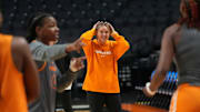 Tennessee basketball coach Kim Caldwell smiles as her team warms up before practice at the NCAA college basketball tournament on Friday, March 28, 2025, in Birmingham, AL.