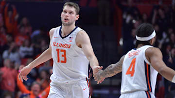 Feb 11, 2025; Champaign, Illinois, USA;  Illinois Fighting Illini center Tomislav Ivisic (13) gets a hand from teammate  Kylan Boswell (4) during the second half against the UCLA Bruins at State Farm Center. Mandatory Credit: Ron Johnson-Imagn Images