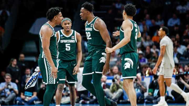 Michigan State guard A.J. Hoggard (11), guard Tre Holloman (5) and center Mady Sissoko (22) celebrate a play against Mississippi State during the second half of NCAA tournament West Region first round at Spectrum Center in Charlotte, N.C. on Thursday, March 21, 2024.