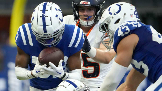 Colts cornerback Micah Abraham (blue jersey with white helmet) muscles away the football for a defensive turnover. 