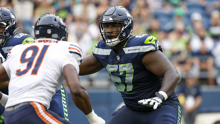 Seattle Seahawks offensive tackle Charles Cross blocks against the Chicago Bears. Seattle Seahawks offensive tackle Charles Cross blocks against the Chicago Bears.