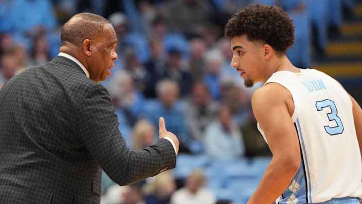 North Carolina Tar Heels head coach Hubert Davis with guard Derek Dixon (3)