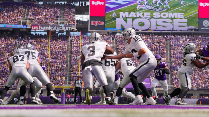 Aug 10, 2024; Minneapolis, Minnesota, USA; Las Vegas Raiders quarterback Aidan O'Connell (12) hands the ball off to running back Zamir White (3) against the Minnesota Vikings in the first quarter at U.S. Bank Stadium. Mandatory Credit: Brad Rempel-USA TODAY Sports