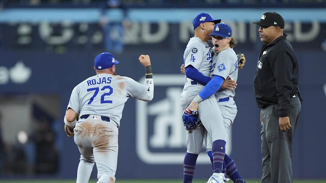 Oct 31, 2025; Toronto, Ontario, CAN; Los Angeles Dodgers second baseman Miguel Rojas (72) and shortstop Mookie Betts (50) and first baseman Enrique Hernandez (8) celebrate after defeating the Toronto Blue Jays during game six of the 2025 MLB World Series at Rogers Centre. Mandatory Credit: John E. Sokolowski-Imagn Images