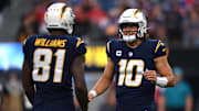 Los Angeles Chargers quarterback Justin Herbert (10) talks to wide receiver Mike Williams (81) during the second half at SoFi Stadium. 