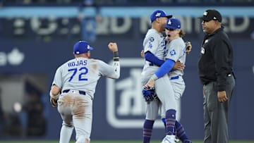 Oct 31, 2025; Toronto, Ontario, CAN; Los Angeles Dodgers second baseman Miguel Rojas (72) and shortstop Mookie Betts (50) and first baseman Enrique Hernandez (8) celebrate after defeating the Toronto Blue Jays during game six of the 2025 MLB World Series at Rogers Centre. Mandatory Credit: John E. Sokolowski-Imagn Images
