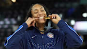 USA forward A'Ja Wilson (9) celebrates with the gold medal after defeating France at the 2024 Paris Olympics.