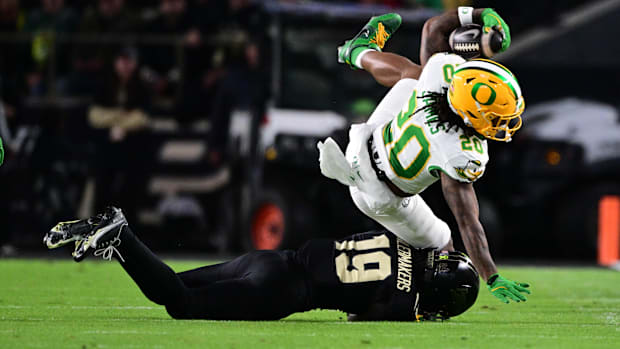 Oct 18, 2024; West Lafayette, Indiana, USA; Oregon Ducks running back Jordan James (20) is tackled by Purdue Boilermakers def