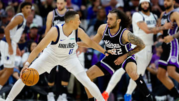 Dallas Mavericks guard Dante Exum is defended by Sacramento Kings guard Devin Carter.