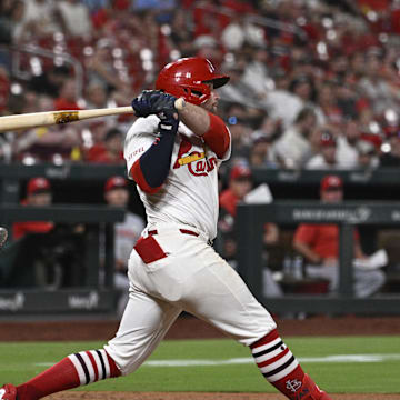 Sep 15, 2025; St. Louis, Missouri, USA; St. Louis Cardinals second baseman Brendan Donovan (21) hits a single against the Cincinnati Reds in the sixth inning at Busch Stadium. Mandatory Credit: Joe Puetz-Imagn Images