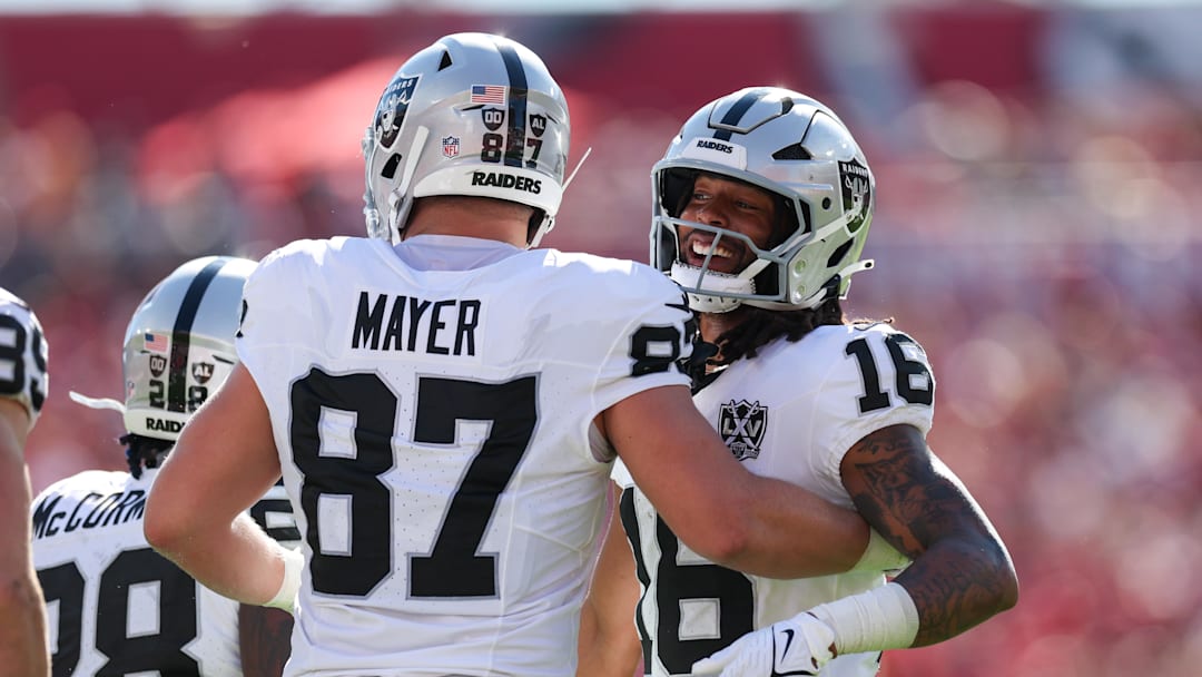 Dec 8, 2024; Tampa, Florida, USA; Las Vegas Raiders wide receiver Jakobi Meyers (16) and tight end Michael Mayer (87) celebrate after a play against the Tampa Bay Buccaneers in the first quarter at Raymond James Stadium. Mandatory Credit: Nathan Ray Seebeck-Imagn Images