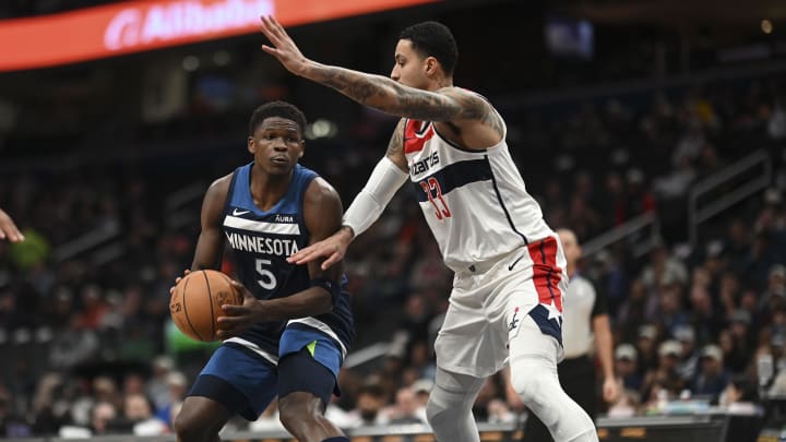 Jan 24, 2024; Washington, District of Columbia, USA;  Minnesota Timberwolves guard Anthony Edwards (5) looks to pass in the paint as Washington Wizards forward Kyle Kuzma (33) defends during the first half at Capital One Arena. Mandatory Credit: Tommy Gilligan-USA TODAY Sports