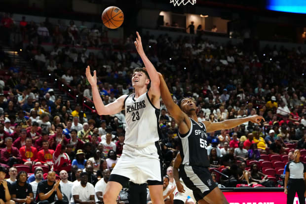 Portland Trail Blazers center Donovan Clingan (23) looks to take a rebound from San Antonio Spurs forward Harrison Ingram.