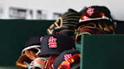 Apr 24, 2022; Cincinnati, Ohio, USA; A view of St. Louis Cardinals players    hats and gloves in the dugout during a game with the Cincinnati Reds at Great American Ball Park. Mandatory Credit: David Kohl-Imagn Images